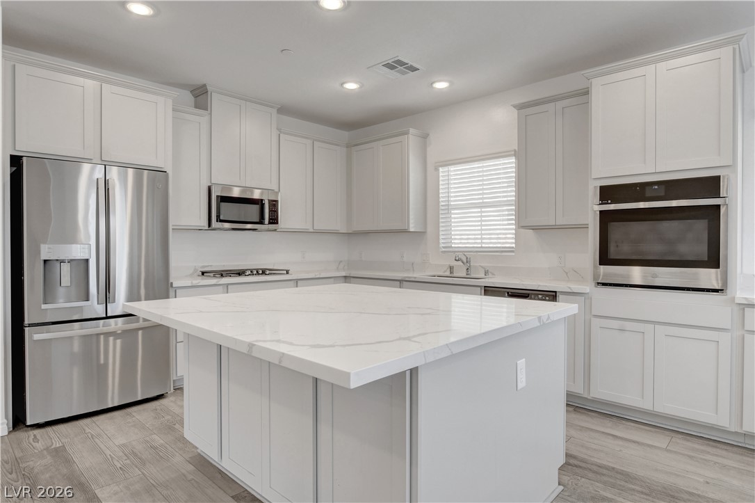 2555 Hampton Road, Unit 2207 Henderson, NV 89052 - Photo 12 of 74 A gourmet kitchen boasts a spacious island and gleaming stainless steel appliances.