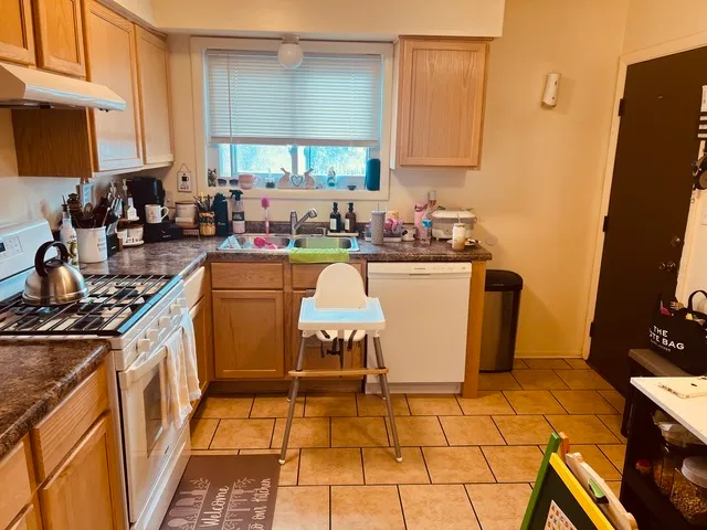 a kitchen with a sink appliances and cabinets