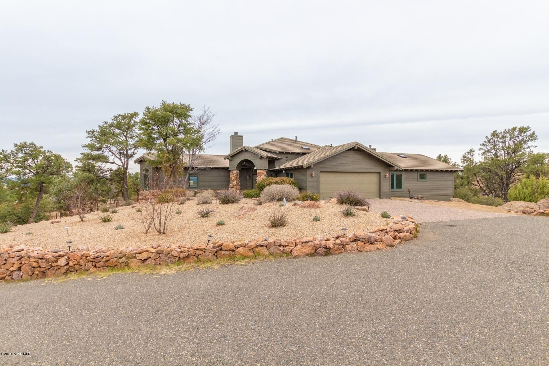 16500 Petroglyph Road Prescott, AZ 86305 - Photo 3 of 71 a front view of a house with a yard covered in snow