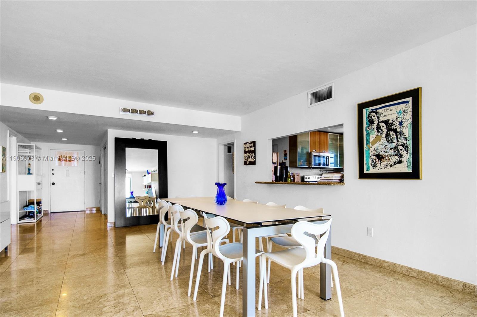 5825 Collins Avenue, Unit 10G Miami Beach, FL 33140 - Photo 11 of 51 a living room with furniture and a flat screen tv