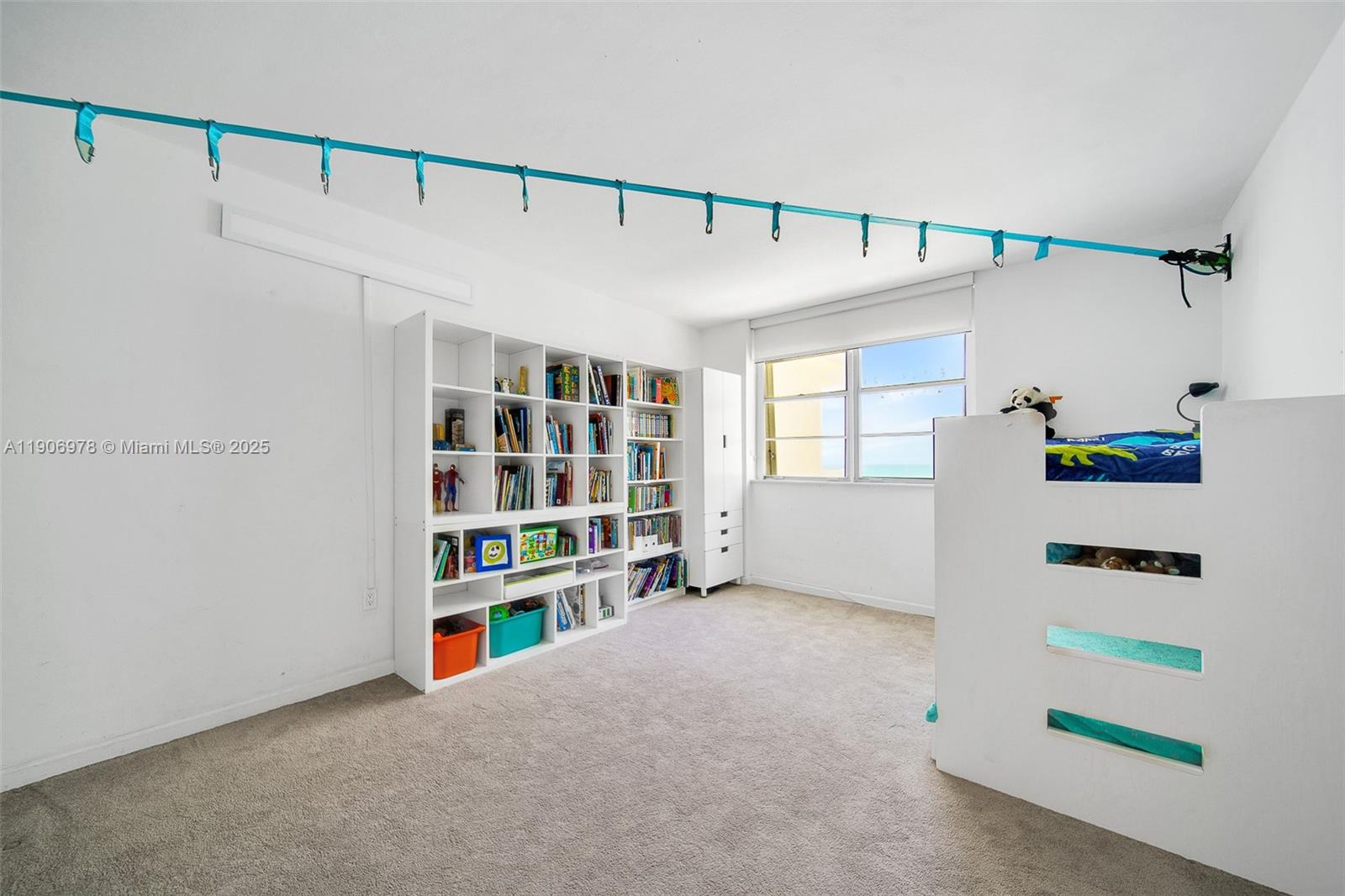 5825 Collins Avenue, Unit 10G Miami Beach, FL 33140 - Photo 15 of 51 a view of an empty room with shelves and book shelf