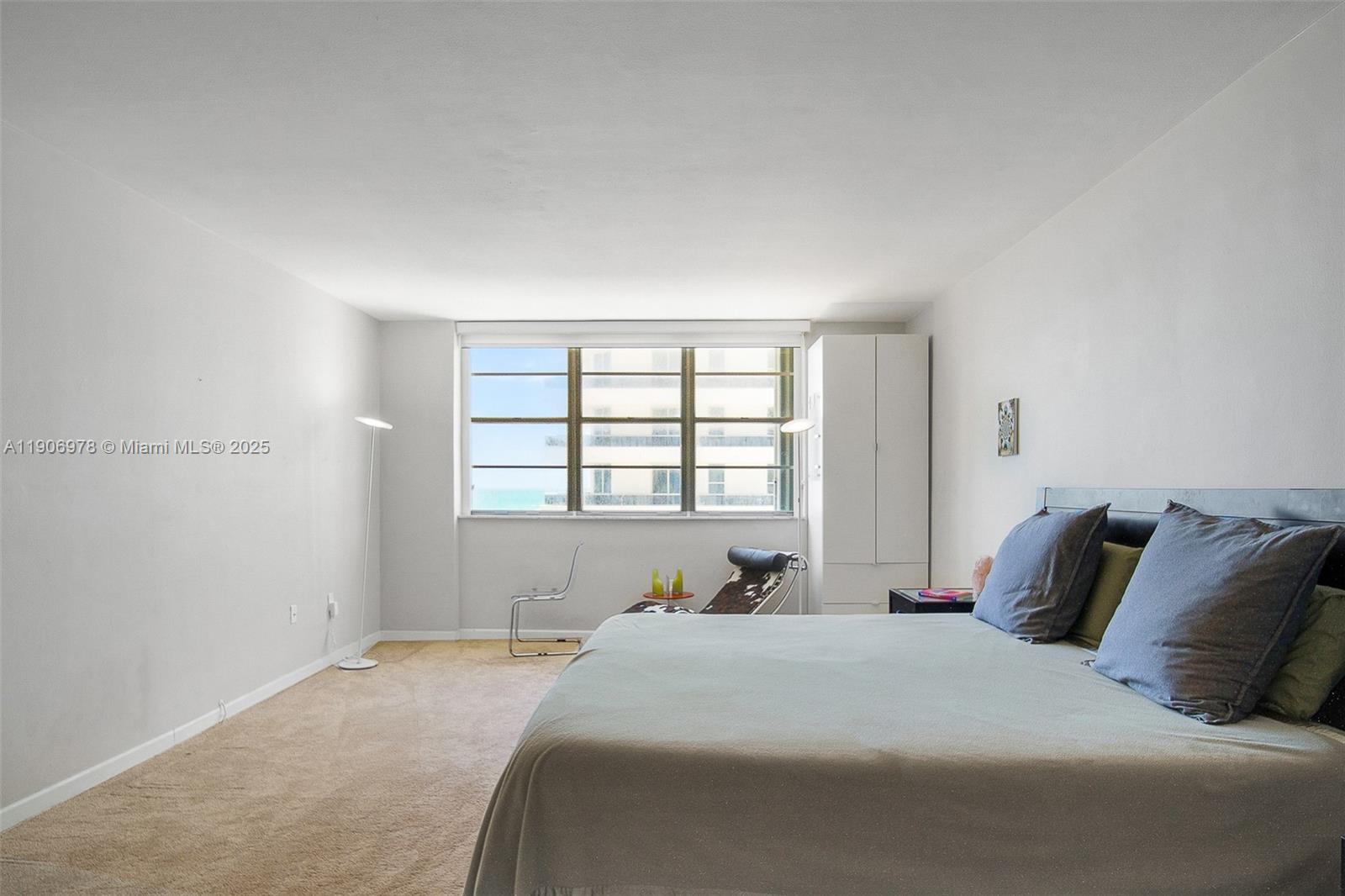 5825 Collins Avenue, Unit 10G Miami Beach, FL 33140 - Photo 28 of 51 a bedroom with a bed and a window