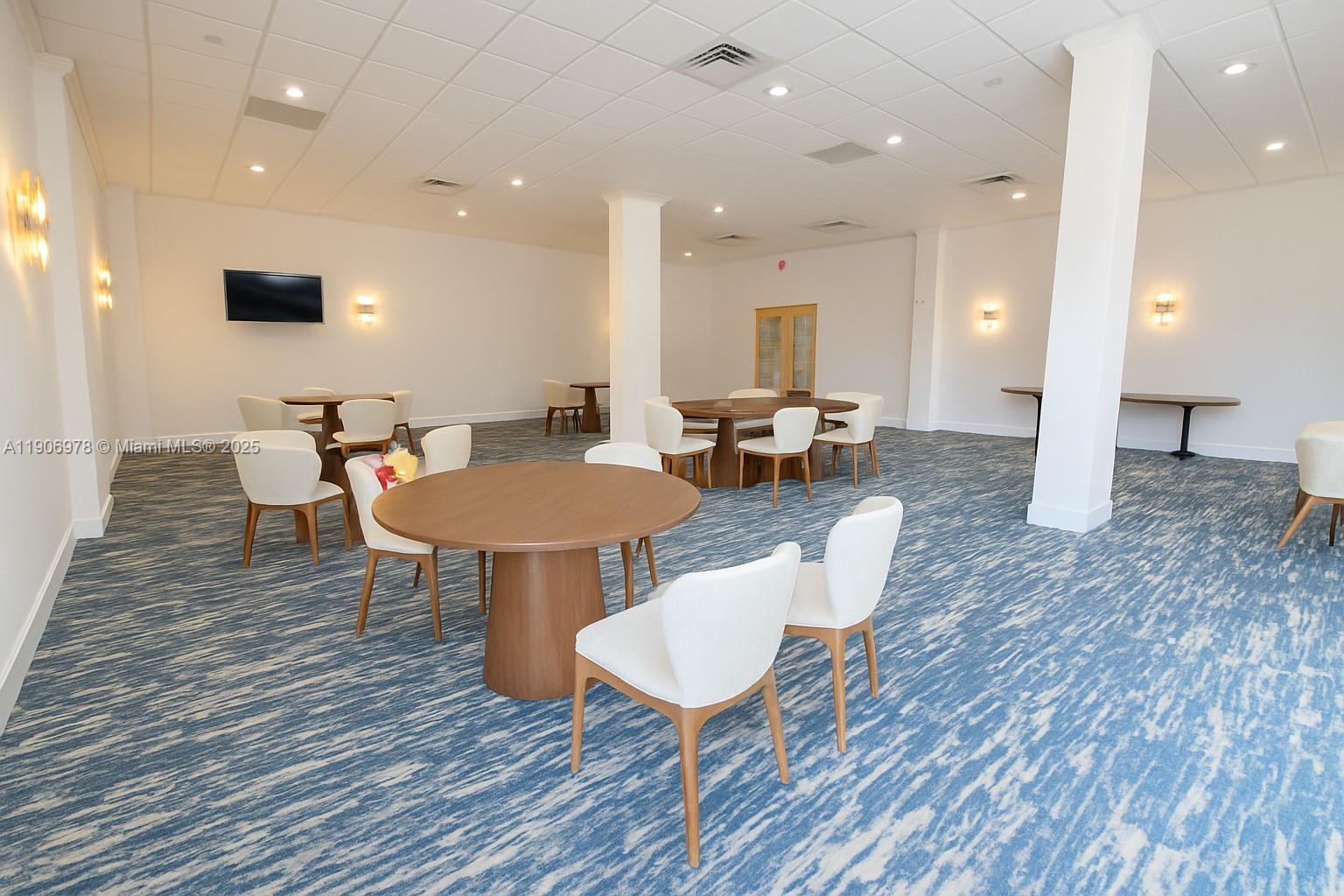 5825 Collins Avenue, Unit 10G Miami Beach, FL 33140 - Photo 30 of 51 an open kitchen with dining table and chairs