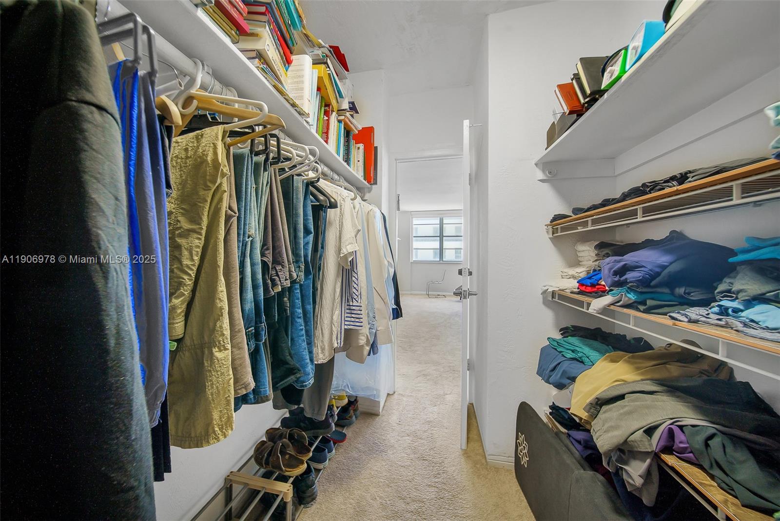 5825 Collins Avenue, Unit 10G Miami Beach, FL 33140 - Photo 32 of 51 a view of walk in closet with clothes and shoes