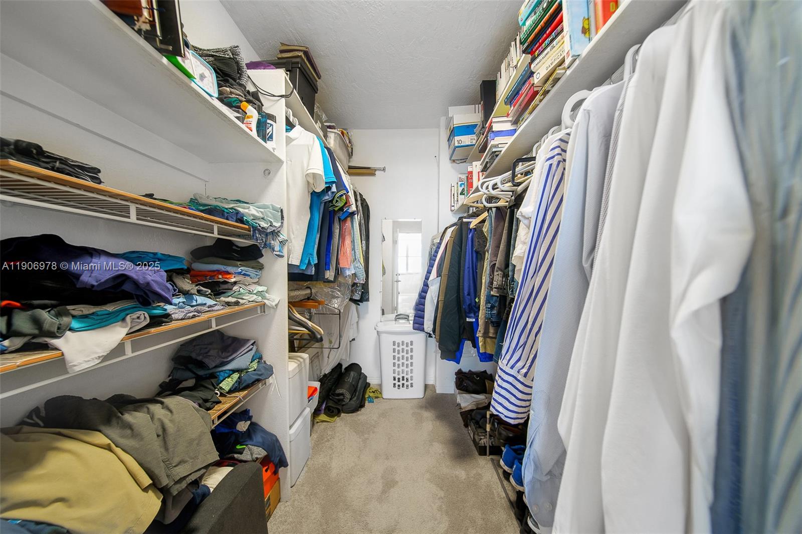 5825 Collins Avenue, Unit 10G Miami Beach, FL 33140 - Photo 33 of 51 a view of walk in closet with clothes and shoes