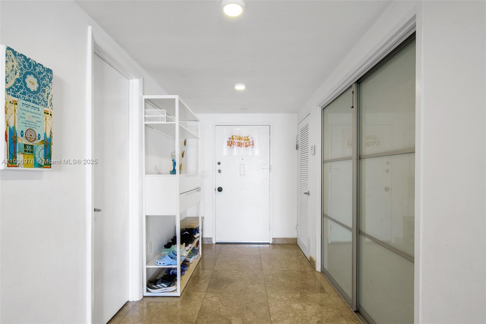 5825 Collins Avenue, Unit 10G Miami Beach, FL 33140 - Photo 40 of 51 a view of a hallway with wooden floor and entryway
