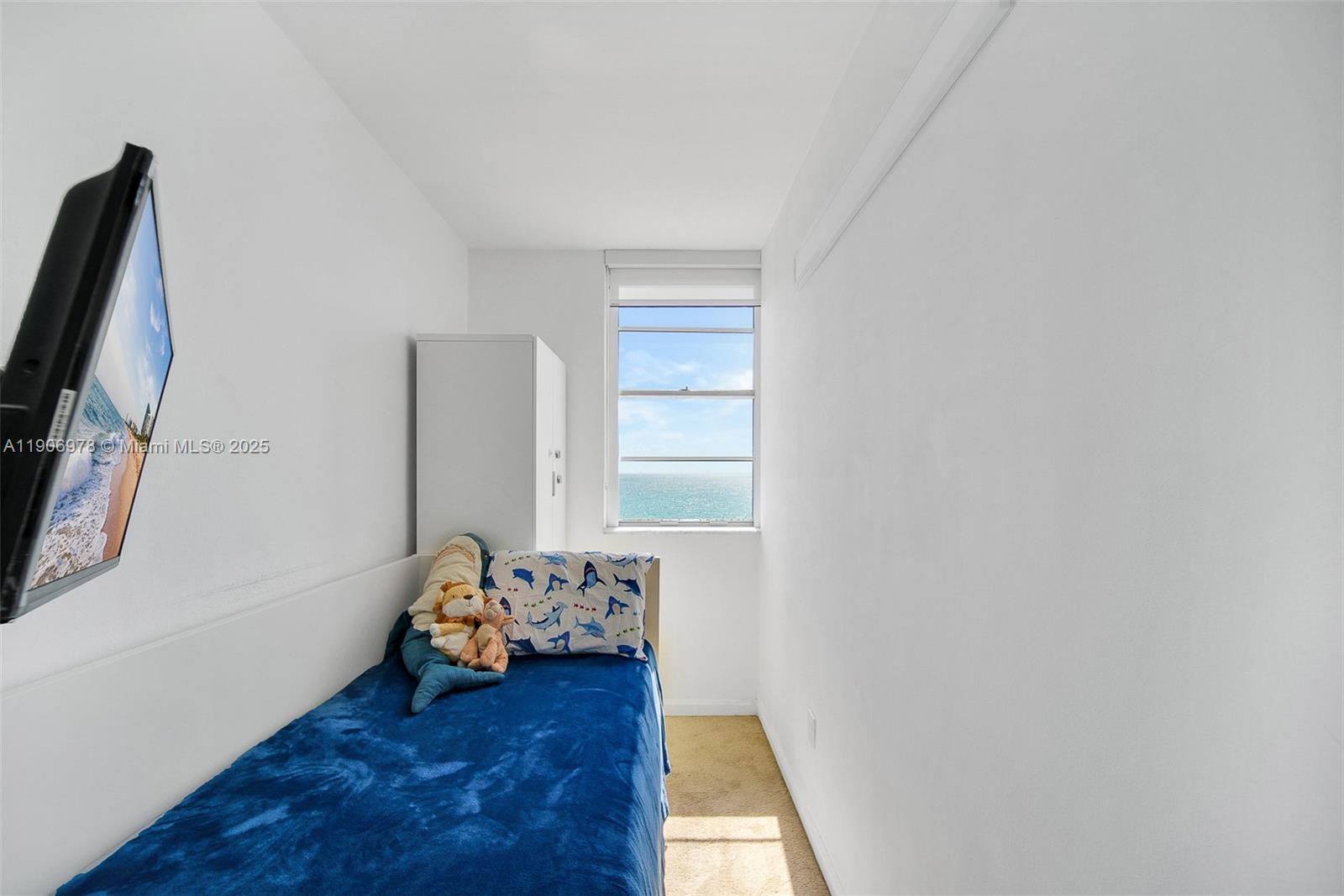 5825 Collins Avenue, Unit 10G Miami Beach, FL 33140 - Photo 41 of 51 a view of a room with wooden floor and a window