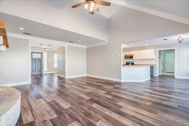 a view of a kitchen with a dishwasher cabinets and wooden floor