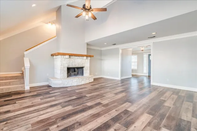 a view of an empty room with a fireplace and a window