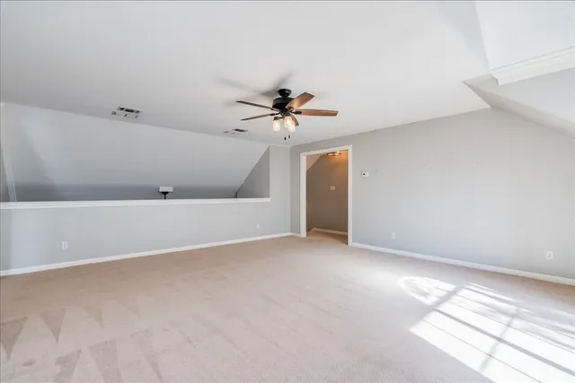 an empty room with a ceiling fan and a window