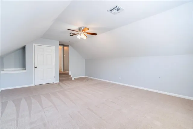a view of empty room with a ceiling fan