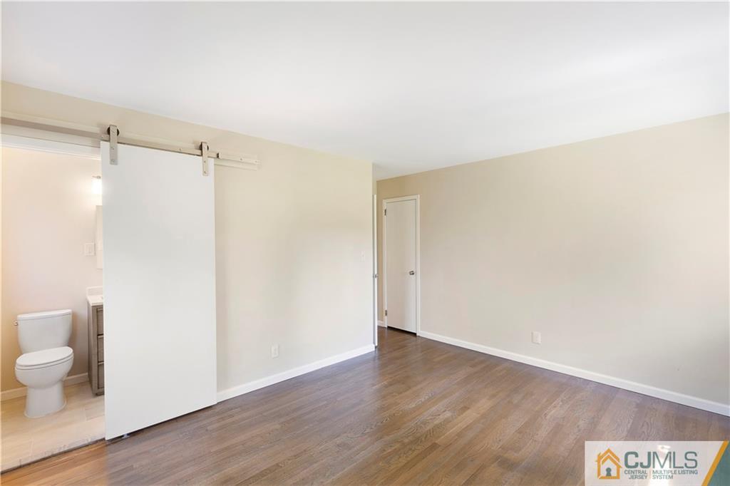 144 Devon Road Colonia, NJ 07067 - Photo 14 of 24 a view of a room with wooden floor and fan