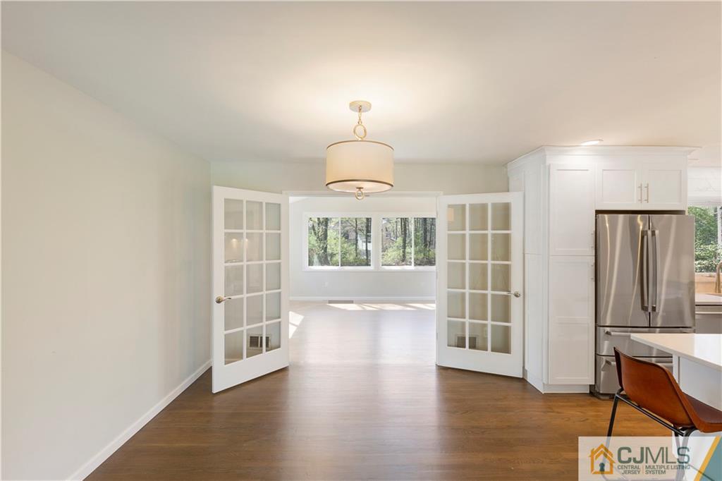 144 Devon Road Colonia, NJ 07067 - Photo 8 of 24 an empty room with wooden floor and windows