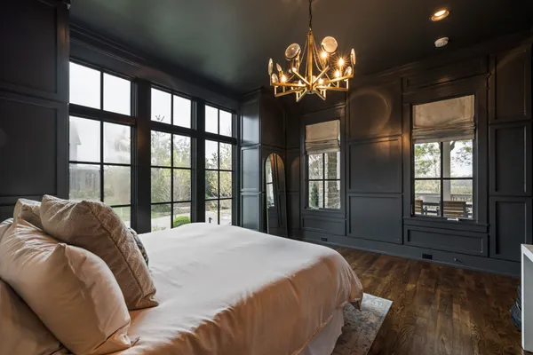 a living room with furniture a fireplace and a large window