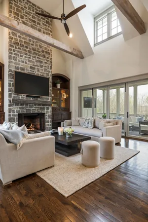 a kitchen with stainless steel appliances a dining table chairs and granite counter tops