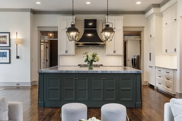 a kitchen with stainless steel appliances granite countertop a stove and cabinets