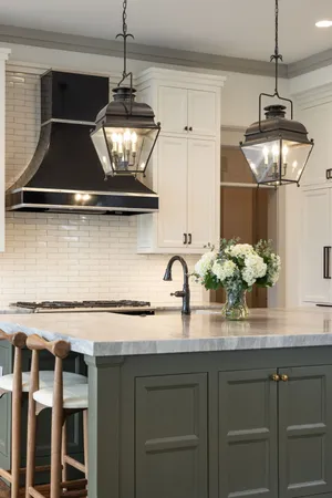 a kitchen with stainless steel appliances kitchen island granite countertop a refrigerator and a sink