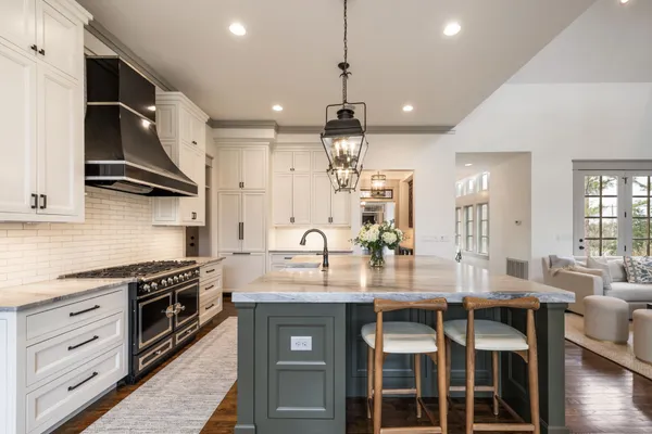 a spacious bedroom with a bed and a chandelier