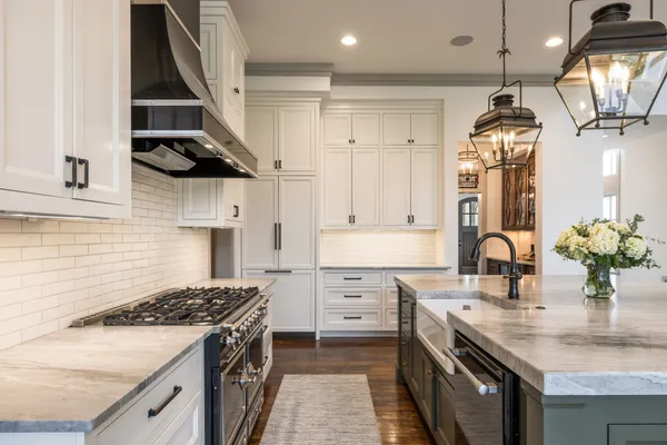 a bathroom with a tub shower vanity and sink