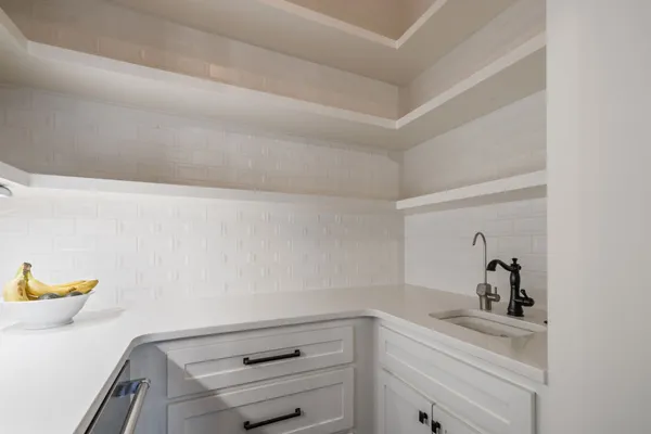 a bathroom with a granite countertop toilet a sink a shower and a mirror