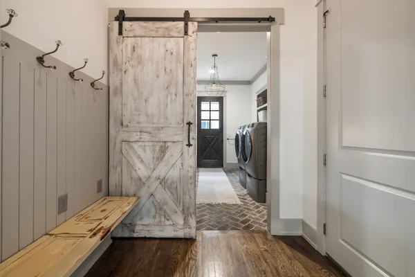 a bathroom with a granite countertop sink a toilet and a window