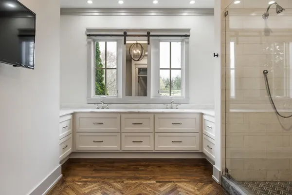 a living room with furniture a flat screen tv and a large window