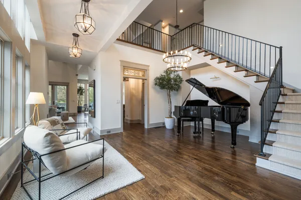 a bedroom with a large bed and a chandelier