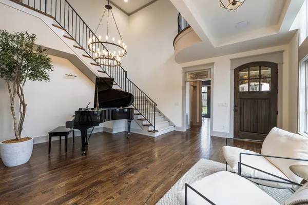 a bedroom with a large bed and a chandelier