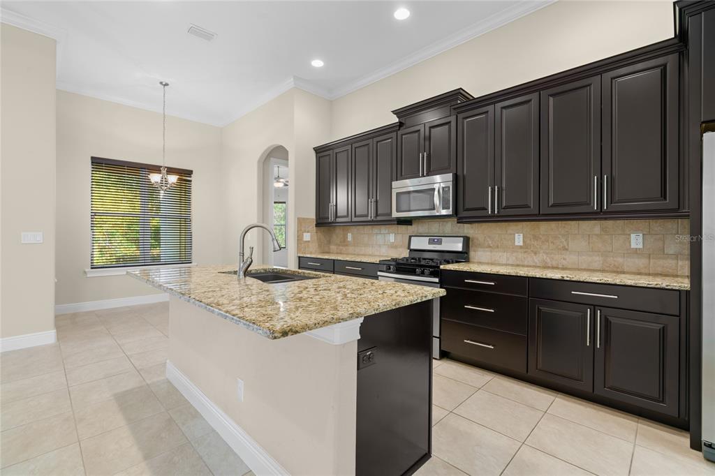 4117 Southeast 21st Street Ocala, FL 34471 - Photo 11 of 38 a kitchen with a sink stove and cabinets
