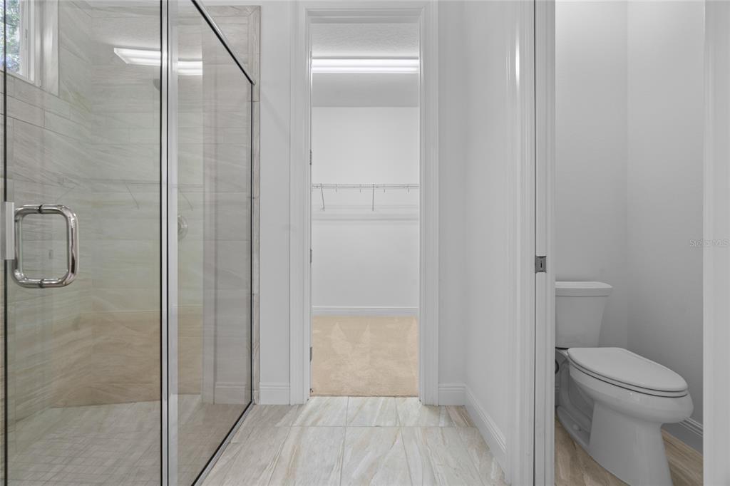 4117 Southeast 21st Street Ocala, FL 34471 - Photo 20 of 38 a bathroom with a granite countertop toilet and a shower