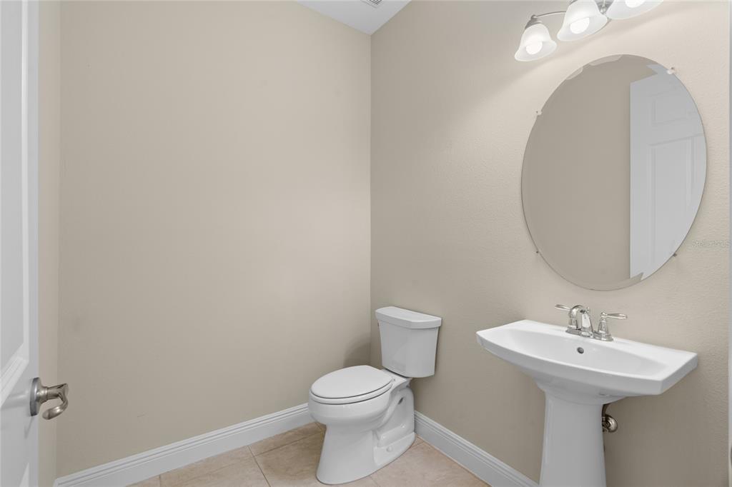 4117 Southeast 21st Street Ocala, FL 34471 - Photo 31 of 38 a bathroom with a sink a toilet and mirror