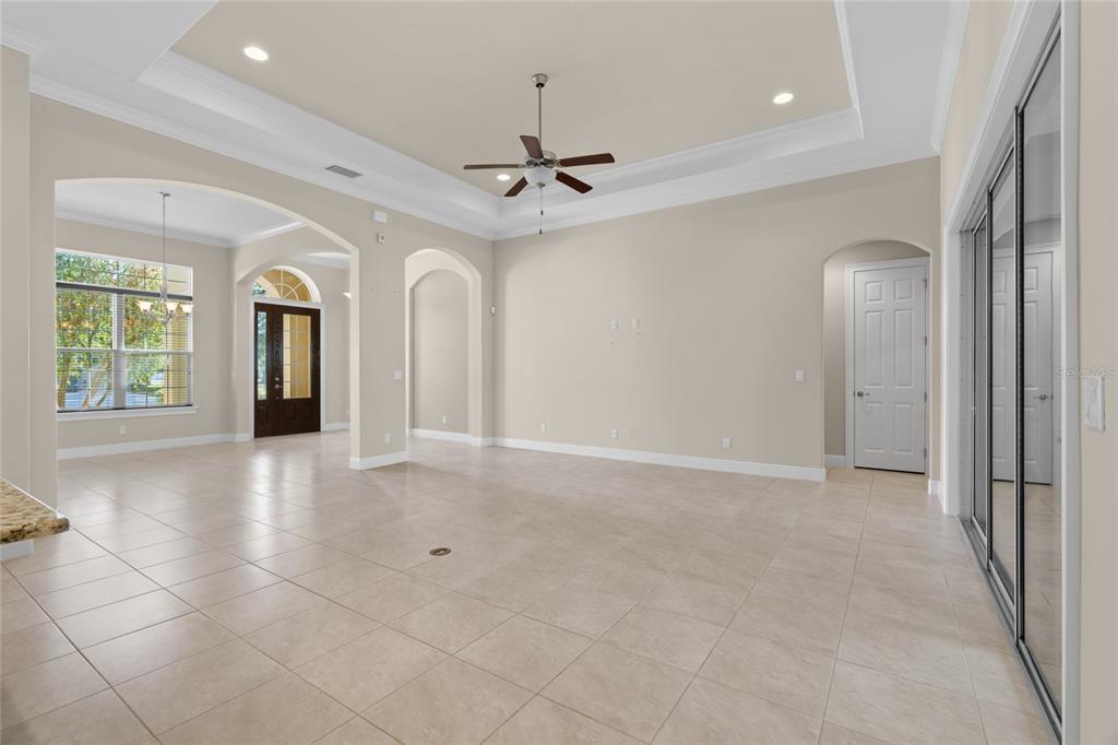 4117 Southeast 21st Street Ocala, FL 34471 - Photo 8 of 38 an empty room with chandelier fan and windows