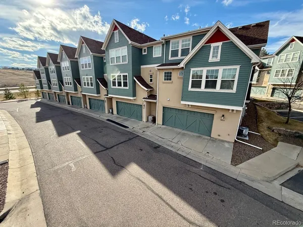 a front view of house with yard outdoor seating and covered with trees