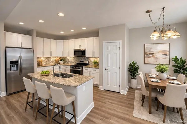 an empty room with wooden floor cabinet and windows