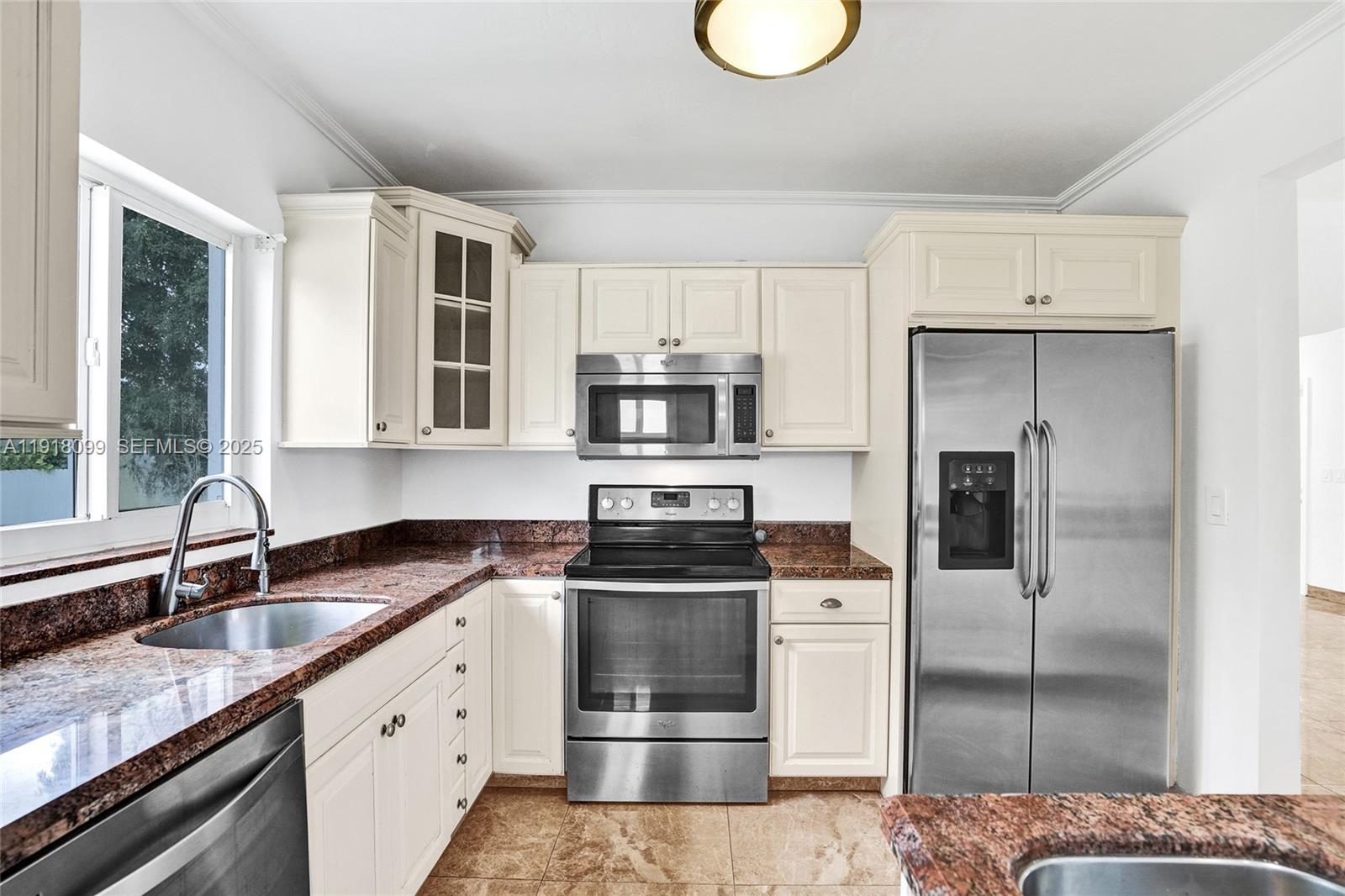 5801 Southwest 20th Street Miami, FL 33155 - Photo 15 of 40 a kitchen with stainless steel appliances granite countertop a sink a stove and a refrigerator