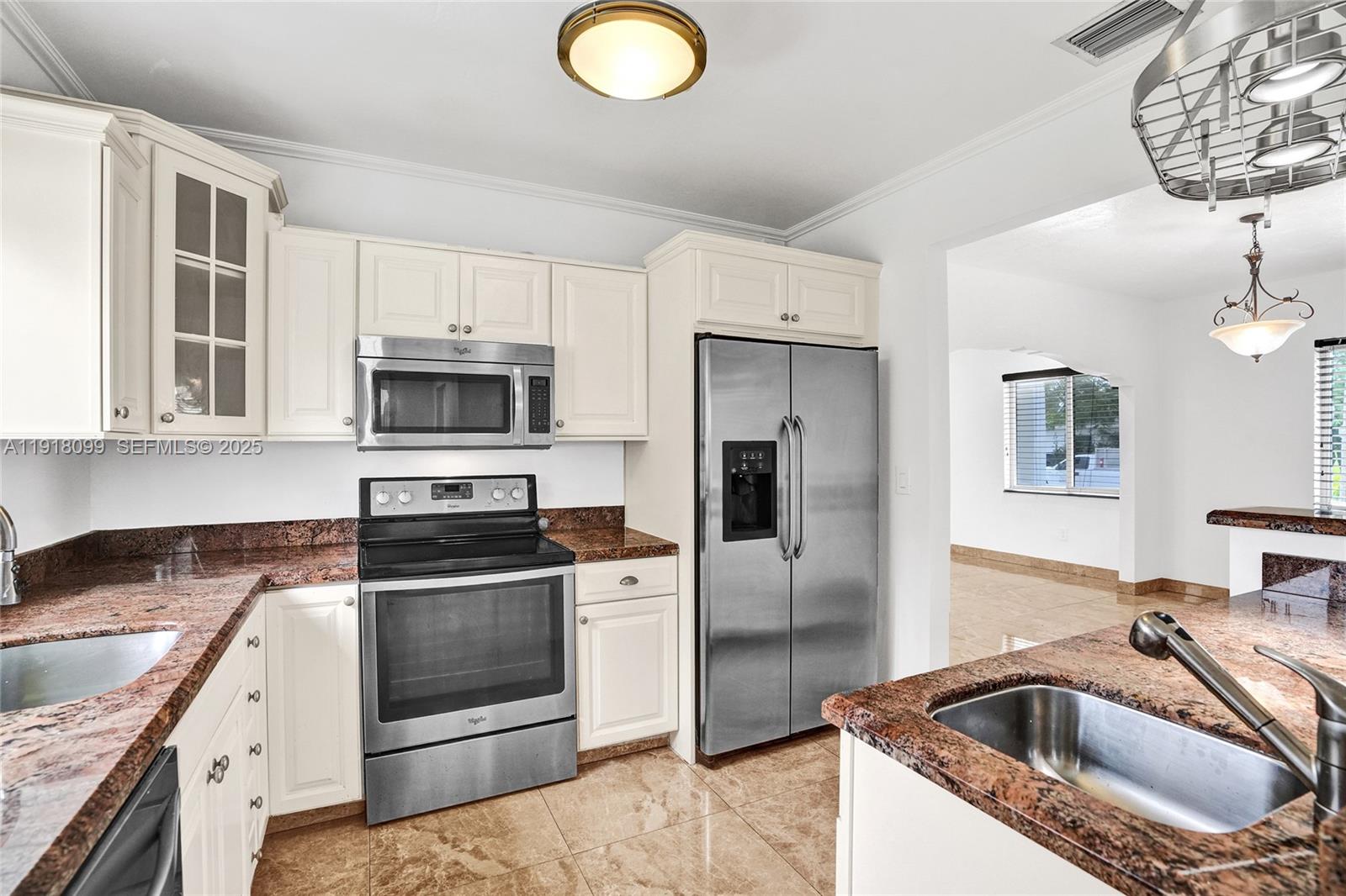5801 Southwest 20th Street Miami, FL 33155 - Photo 16 of 40 a kitchen with a sink stainless steel appliances and cabinets