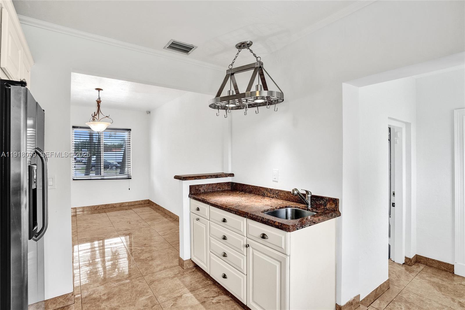 5801 Southwest 20th Street Miami, FL 33155 - Photo 17 of 40 a kitchen with stainless steel appliances kitchen island a refrigerator and stove