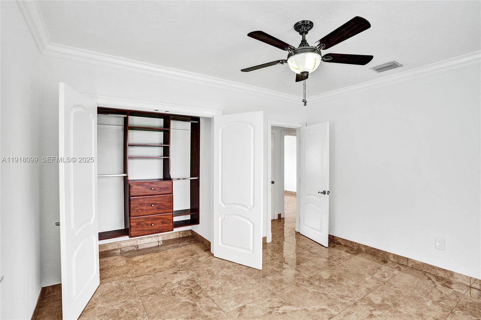 5801 Southwest 20th Street Miami, FL 33155 - Photo 26 of 40 an empty room with closet and ceiling fan