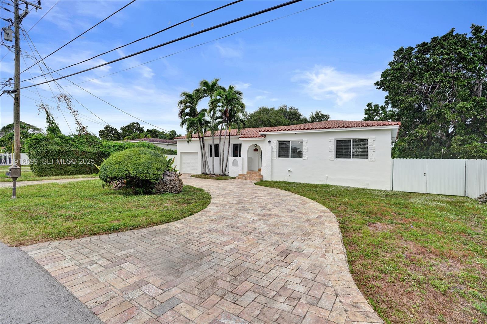 5801 Southwest 20th Street Miami, FL 33155 - Photo 34 of 40 a front view of a house with a yard and garage