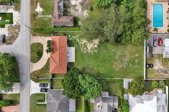 an aerial view of residential house with outdoor space and swimming pool