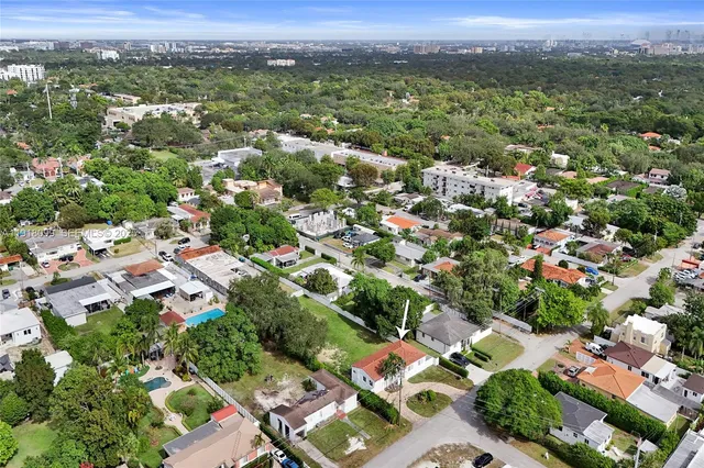 an aerial view of residential houses with outdoor space and street view