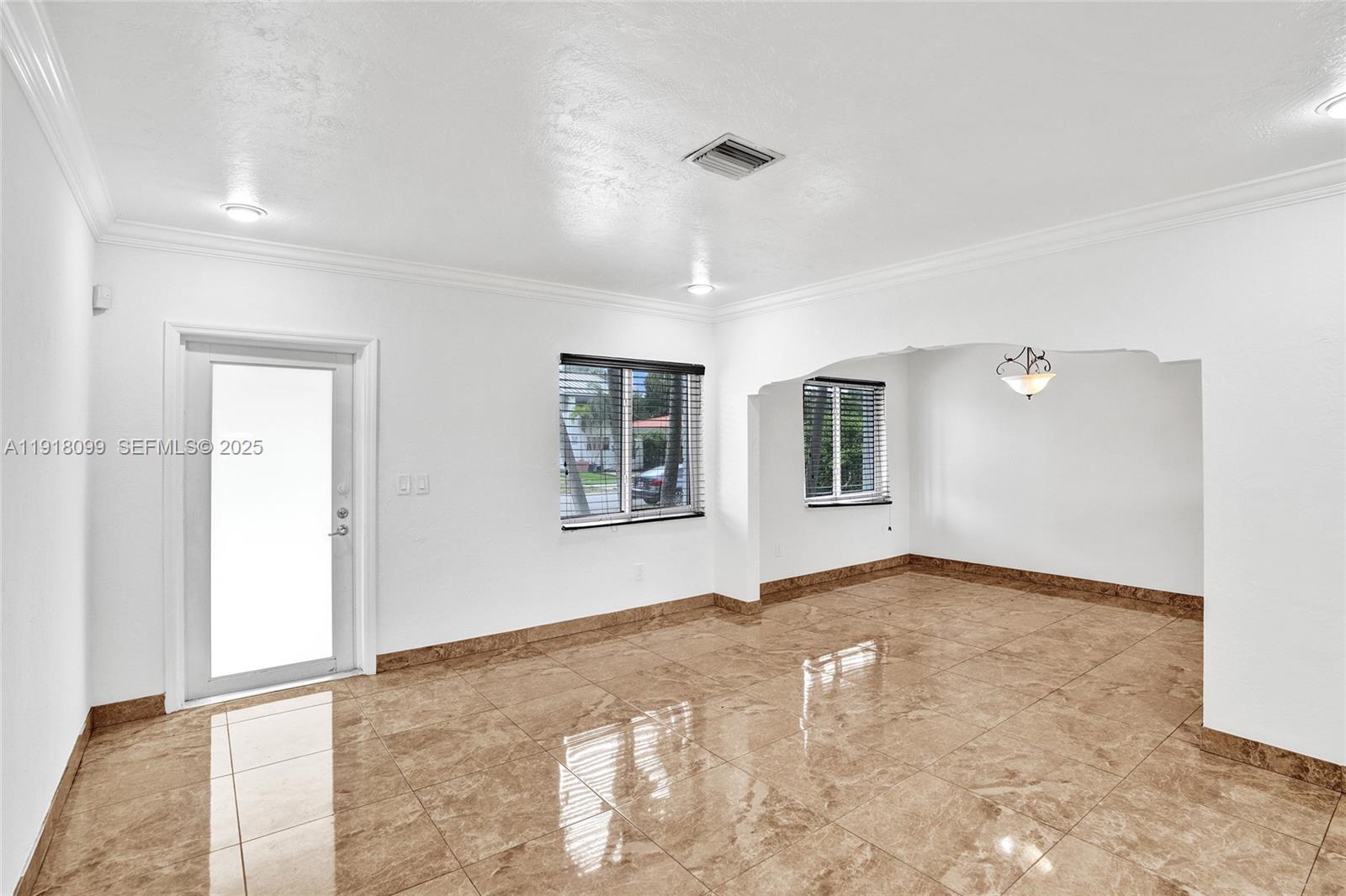 5801 Southwest 20th Street Miami, FL 33155 - Photo 5 of 40 a view of an empty room with window and wooden floor