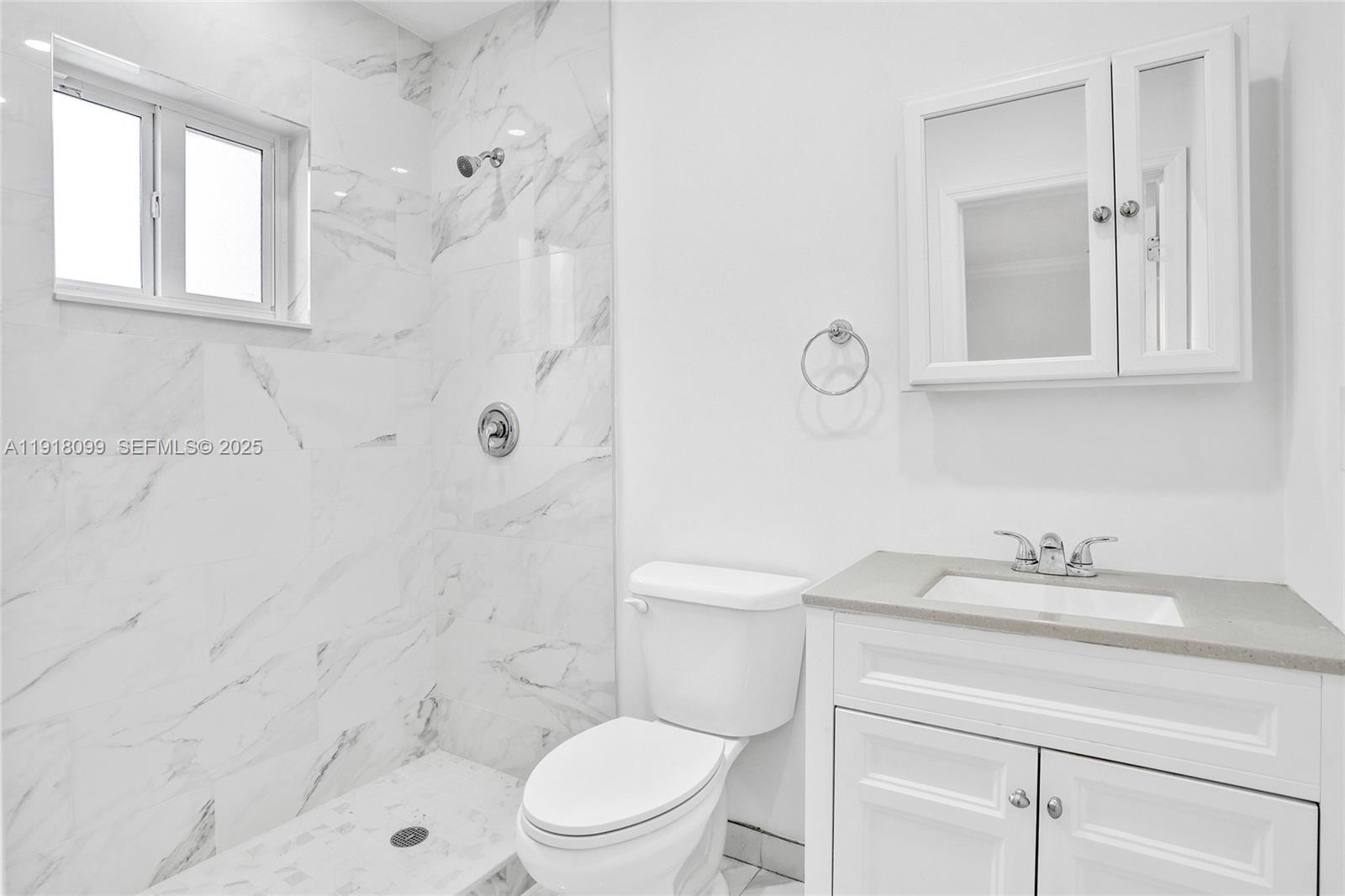 5801 Southwest 20th Street Miami, FL 33155 - Photo 9 of 40 a bathroom with a sink a toilet and shower