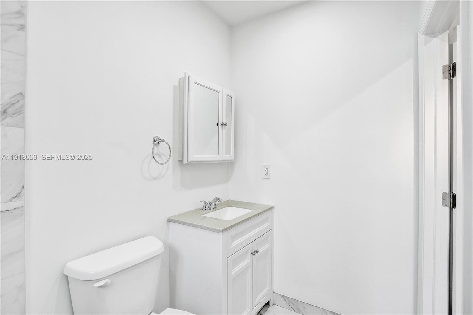 5801 Southwest 20th Street Miami, FL 33155 - Photo 10 of 40 a bathroom with a sink toilet and a mirror