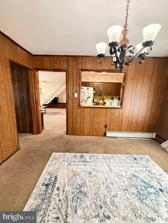 a view of a room with a bed and wooden floor