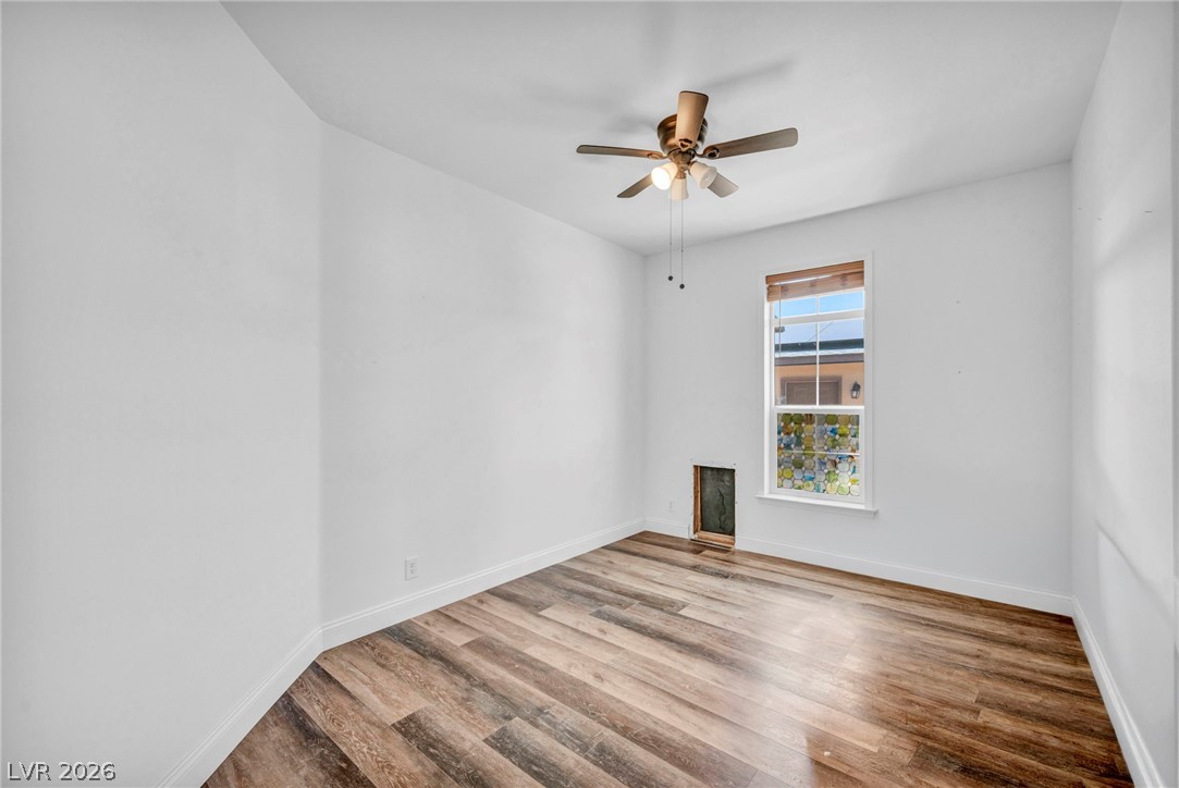 225 California Street Searchlight, NV 89046 - Photo 39 of 64 Hardwood-style flooring extends through this airy room, highlighted by a window and a ceiling fan for comfort.