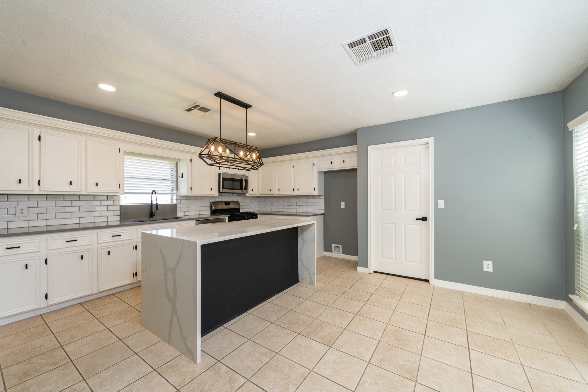 1022 White Sands Road Katy, TX 77450 - Photo 10 of 27 The beautifully remodeled kitchen showcases quartz countertops with a waterfall island, oversized black single-bowl sink, and designer backsplash. Water supply lines have been converted to pex.