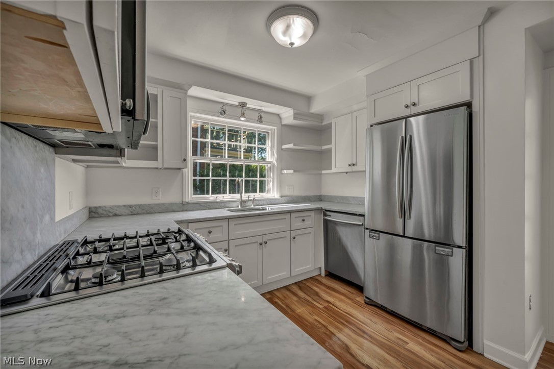 3543 Lytle Road Shaker Heights, OH 44122 - Photo 20 of 49 Kitchen featuring white cabinetry, stone countertops with integrated backsplash, a stainless steel gas range, and a stainless steel French door refrigerator
