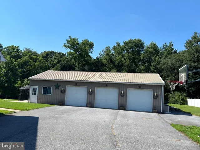 a front view of a house with a garden and garage