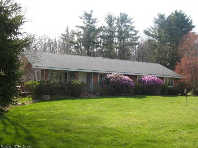 a front view of house with yard and trees